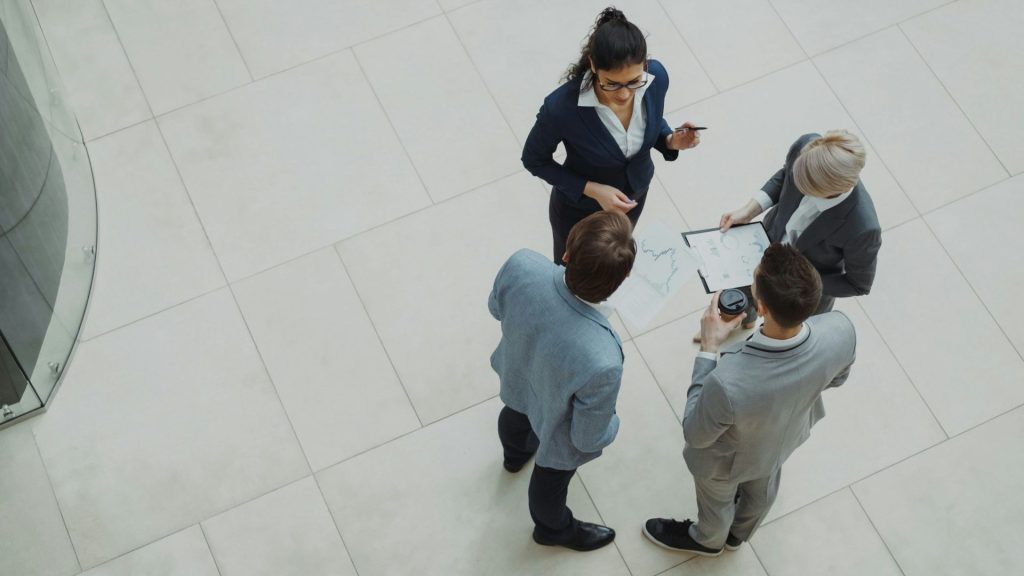 Four business professionals collaborating in a modern office space